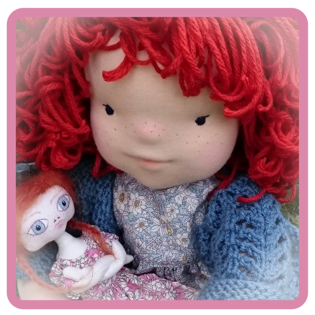 a large Waldorf doll and a small rag doll