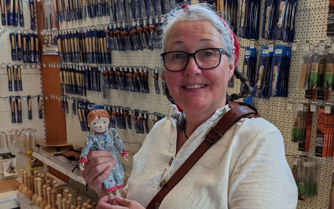 Alison Jackson holding one of her puppets