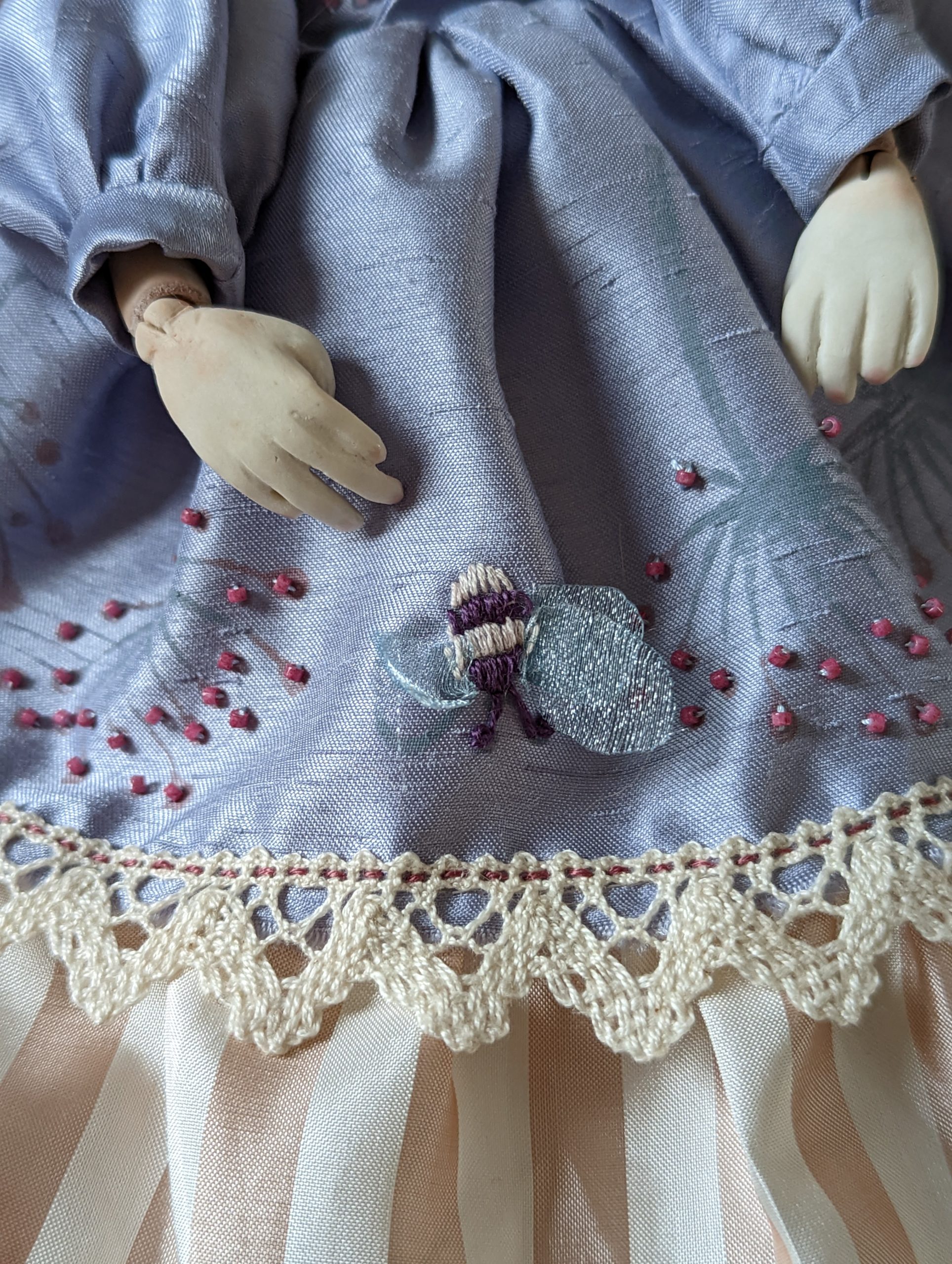 close up of embroidery on art dolls dress