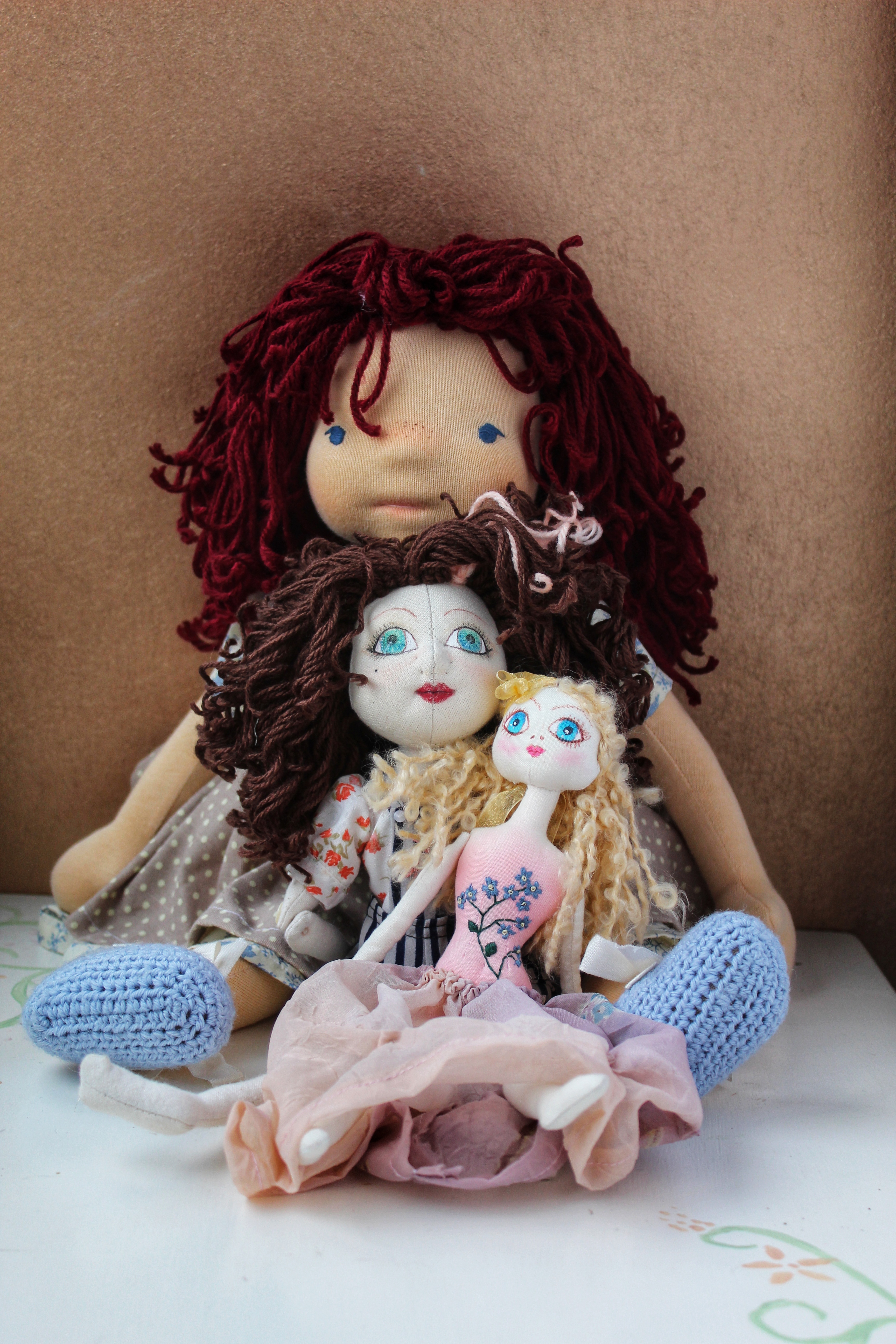 three sizes of cloth art dolls