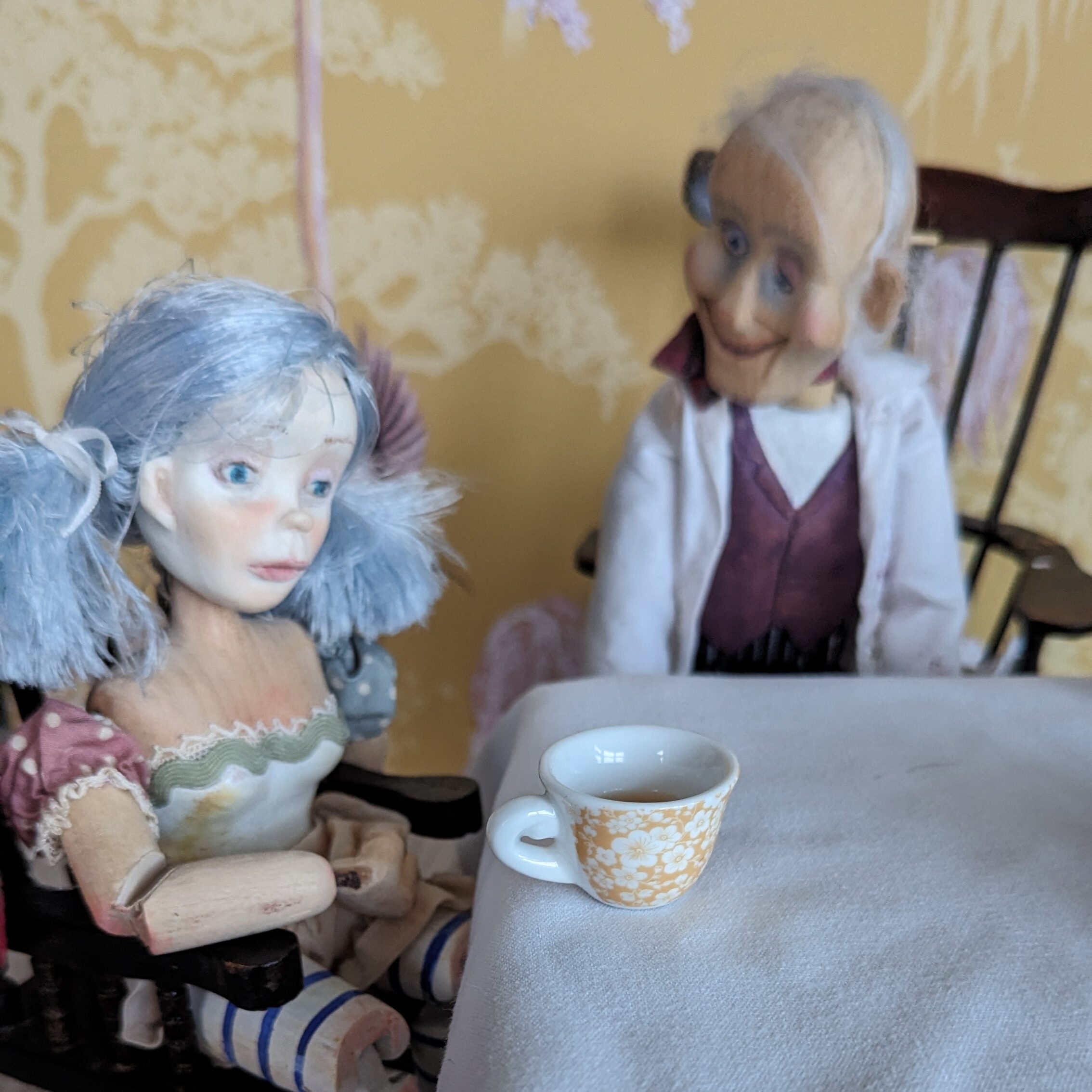 wooden puppets sat down to drink tea